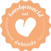 A circular badge with a scalloped edge, featuring a white heart in the center and text in German. Produktbild-Vorschau