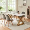 A dining room scene with a marble-look table and chairs, set for a meal. Produktbild-Vorschau