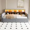 A modern daybed with a built-in bookshelf and LED lighting, set up in a bedroom or living room. Náhled obrázku produktu
