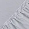 A close-up view of a light gray fitted sheet, showing the texture of the fabric and the elasticized edge. Produktbild-Vorschau
