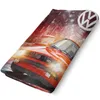 A red Volkswagen Golf GTI car is depicted on a blanket, with a city background and the Volkswagen logo. Produktbild-Vorschau