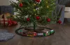 A Christmas tree with a toy train set around its base. Podgląd zdjęcia produktu