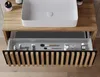 A bathroom vanity with an open drawer displaying toiletries and makeup brushes. Produktbild-Vorschau