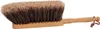 A close-up, studio shot of a hand brush with natural bristles and a wooden handle. Produktbild-Vorschau