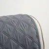 Close-up of a quilted gray sofa cover with a beige trim. Produktbild-Vorschau