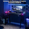 A gaming desk setup with a computer, keyboard, and RGB lighting. Produktbild-Vorschau