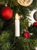 A close-up of a Christmas tree with decorations, including a lit candle-shaped LED light. Produktbild-Vorschau