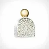 A perfume bottle with a decorative silver cage and a gold cap, isolated on a white background. Podgląd zdjęcia produktu