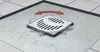 A floor drain with a rotating grate, indicated by red arrows showing movement. Náhled obrázku produktu