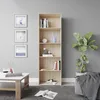A bookshelf filled with books and decorative items, next to a potted plant and a coffee table with books. Voir les images du produit
