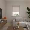 A living room scene with a sectional sofa, a coffee table, a TV stand with flowers, and a window with blinds. Produktbild-Vorschau