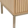 A close-up view of the bottom section of a wooden cabinet with metal legs. Podgląd zdjęcia produktu