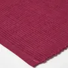 A close-up view of a burgundy ribbed fabric, likely a placemat or textile. Náhled obrázku produktu