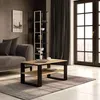 A living room setting with a couch, coffee table, and bookshelf. Voir les images du produit