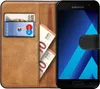 A brown leather wallet case for a Samsung phone, showing a credit card and euro banknotes inside. Produktbild-Vorschau
