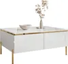 A white, high-gloss coffee table with gold legs and trim, decorated with a bowl and a vase with dried flowers. Produktbild-Vorschau