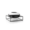 A silver vase with a black rim sits on a black metal stand against a white background. Produktbild-Vorschau