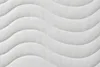 Close-up of a white quilted mattress surface with a wave pattern. Náhľad obrázku produktu