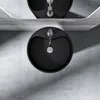 A top-down view of a black washbasin with a silver faucet, set against a concrete wall. Produktbild-Vorschau