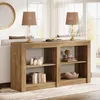 A farmhouse-style console table with shelves, decorated with books, candles, and decorative items, placed behind a sofa in a living room setting. Produktbild-Vorschau