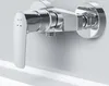A chrome shower faucet mounted on a white wall above a white bathtub. Produktbild-Vorschau