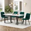 A dining set with a marble-top table and four green velvet chairs in a well-lit room. Podgląd zdjęcia produktu