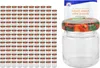 A large stack of small glass jars with fruit-patterned lids, and one jar with a recipe booklet in the background. Produktbild-Vorschau