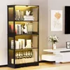 A modern living room scene featuring a black glass display cabinet filled with books and decorative items, alongside a white media console with a vase of flowers and framed artwork on the wall. Náhled obrázku produktu