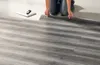 A person is installing vinyl flooring. Produktbild-Vorschau