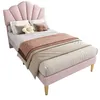 A pink upholstered bed with a shell-shaped headboard, dressed with bedding and pillows, set against a white background. Produktbild-Vorschau