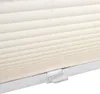 A close-up view of a cream-colored pleated blind with a clear plastic clip attached to the bottom rail. Produktbild-Vorschau