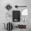 A flat lay of coffee brewing equipment on a gray surface. Voir les images du produit