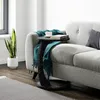 A side table with a book and cup on it, placed next to a sofa in a living room. Anteprima dell’immagine prodotto