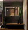 A modern hallway with a large rectangular mirror with LED lighting, a wooden shelf with decorative vases and plants, and a glimpse of a doorway in the reflection. Produktbild-Vorschau