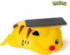 A Pikachu-shaped phone charger with a smartphone placed on top. Produktbild-Vorschau