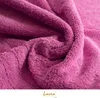 A close-up, textured view of a pink towel. Produktbild-Vorschau
