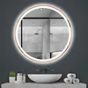 A round, illuminated mirror hangs above a sink in a modern bathroom setting. Produktbild-Vorschau