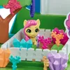 A close-up view of a toy playset with a small yellow pony figure in a fenced area, surrounded by colorful toy accessories. Produktbild-Vorschau