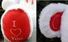 Close-up shots of a white teddy bear's paw with red heart-shaped accents. Náhľad obrázku produktu