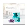 A kitchen counter with a food chopper and a bowl of chopped red onions. Produktbild-Vorschau