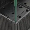 A close-up view of a black planter with a green stake inserted into it. Produktbild-Vorschau