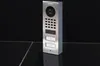 A DoorBird IP-Video-Türstation D1102V is shown against a dark background, resting on a reflective surface. Anteprima dell’immagine prodotto