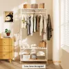 A white garment rack with clothes hanging on it, shelves with storage items, and a chest of drawers next to it. Anteprima dell’immagine prodotto