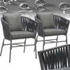 Two outdoor chairs with grey rope detailing and cushions are shown against a white background. The top of the image features a textured grey surface with water droplets. Náhled obrázku produktu