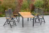 A garden furniture set with a table and chairs on a patio, with a garden in the background. Produktbild-Vorschau