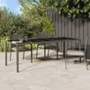 A patio dining set with a table and chairs on a tiled patio, surrounded by greenery and a fence. Náhled obrázku produktu