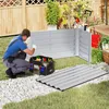 A man is assembling a raised garden bed in a backyard setting. Voir les images du produit