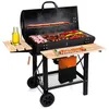 A charcoal grill with food cooking on it, set against a white background.