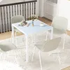 A dining set with a glass-top table and four chairs in a room with a staircase railing. Anteprima dell’immagine prodotto