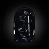 A black backpack with a white digital pattern and reflective elements, set against a dark background. Voir les images du produit